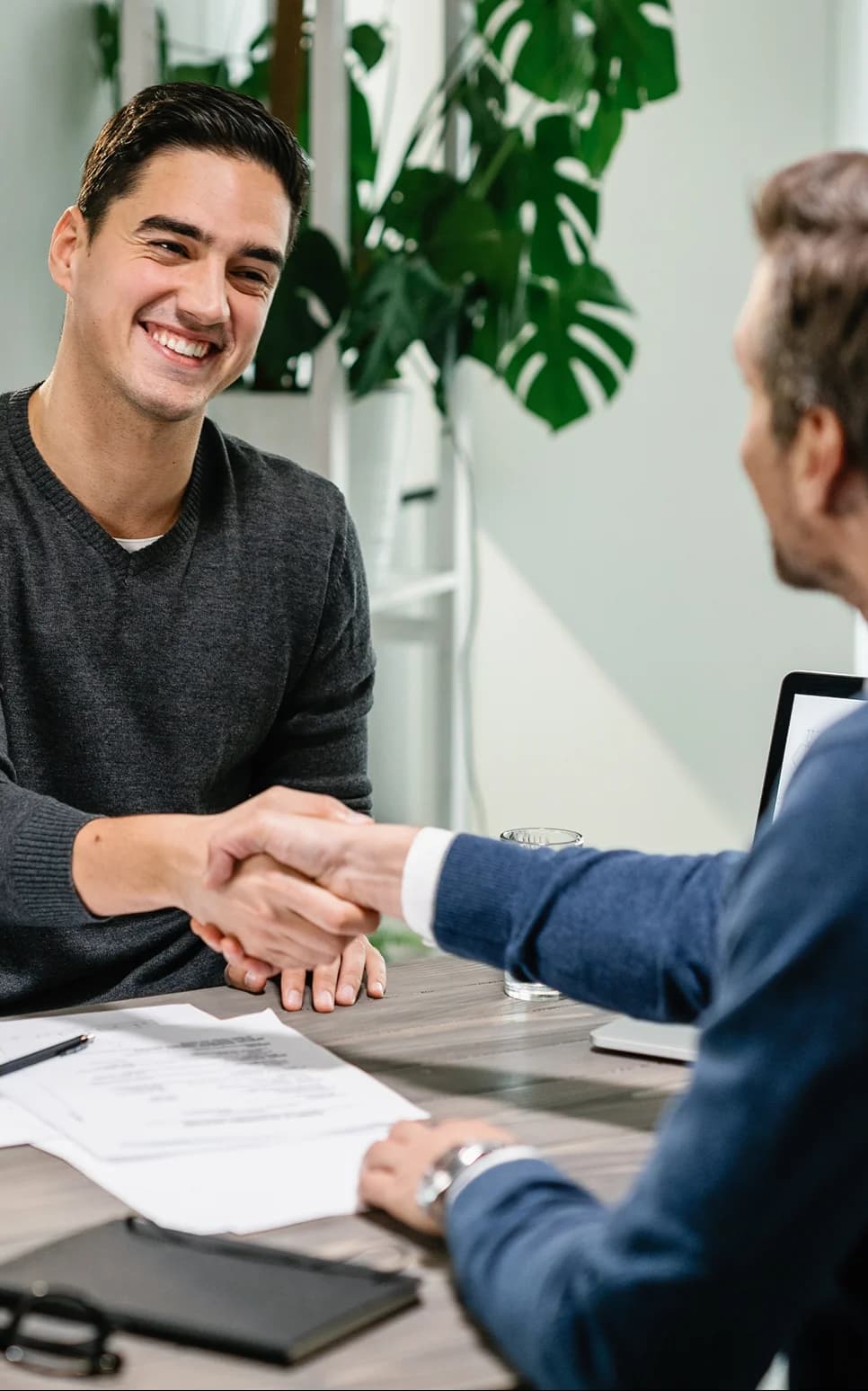 Smiling client shaking hands with a financial advisor